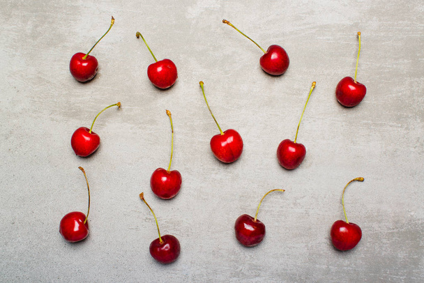 Sweet wild red cherries on concrete background - Φωτογραφία, εικόνα