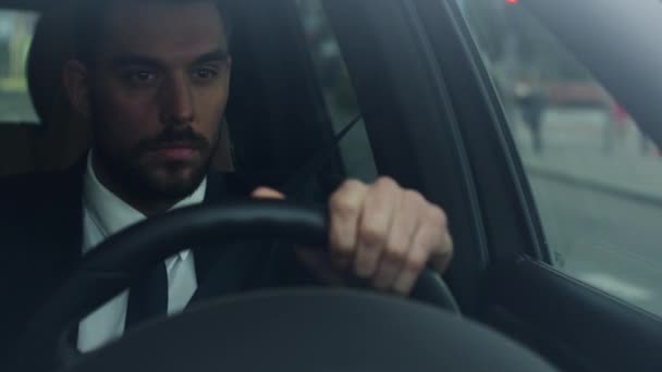 Businessman Driving a Car in Business District, Checking the Time. - Materiał filmowy, wideo