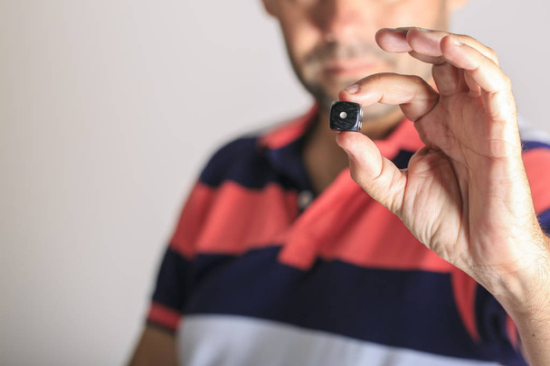 Man showing a dice  in his hand - Photo, Image