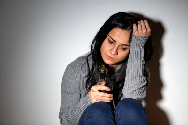 unhappy drunk crying woman with bottle of alcohol - Foto, Imagem