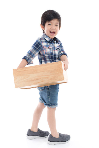 Cute Asian child holding empty wooden box on white background isolated - Фото, изображение