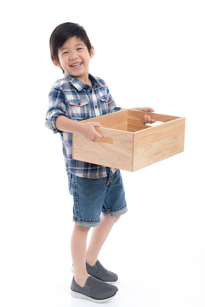 Cute Asian child holding empty wooden box on white background isolated - Photo, Image