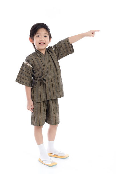 Cute Asian child  in kimono pointing on white background isolated - Photo, Image