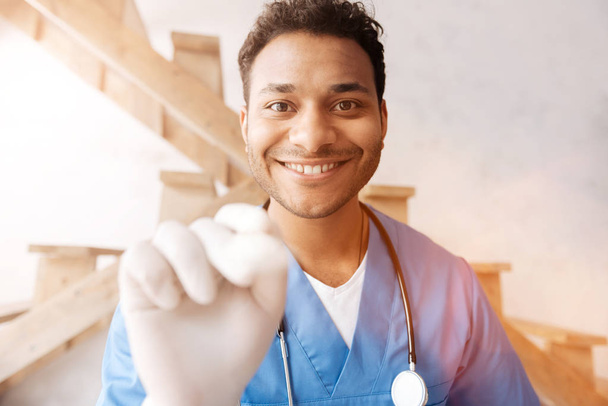 Smiling man in medical uniform doing checkup - Zdjęcie, obraz