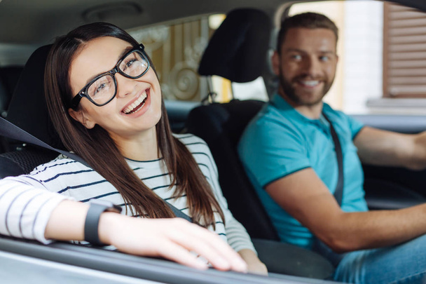 Happy woman sitting in the car next to her boyfriend - Фото, изображение
