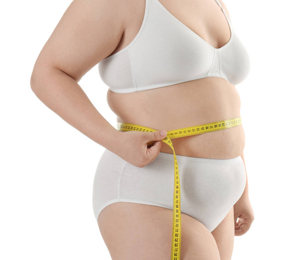 Overweight woman measuring waist - Fotoğraf, Görsel