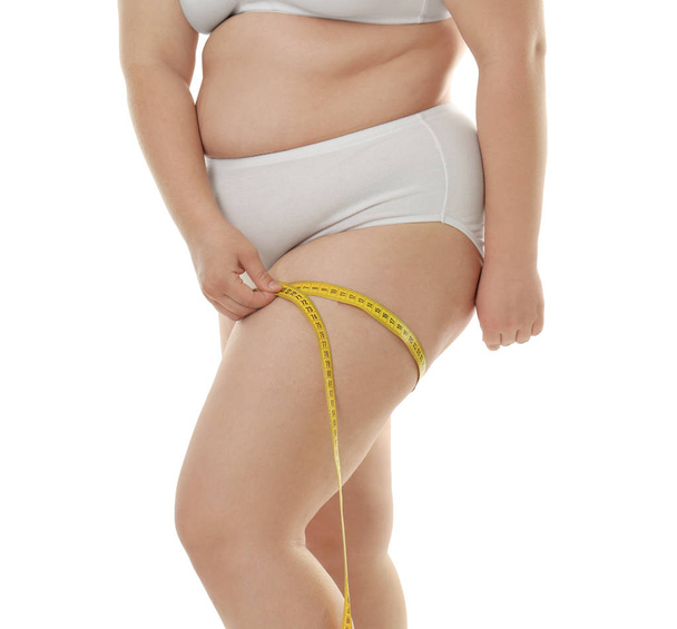 Overweight woman measuring thigh  - Foto, Imagen