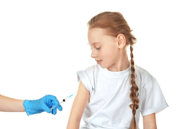 Doctor vaccinating little girl on white background - Foto, Imagen