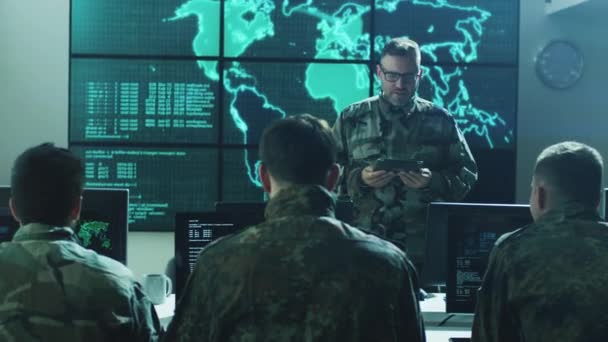 Group of Military IT Professionals on Briefing in Monitoring Room Filled with Displays on Military Base - Záběry, video