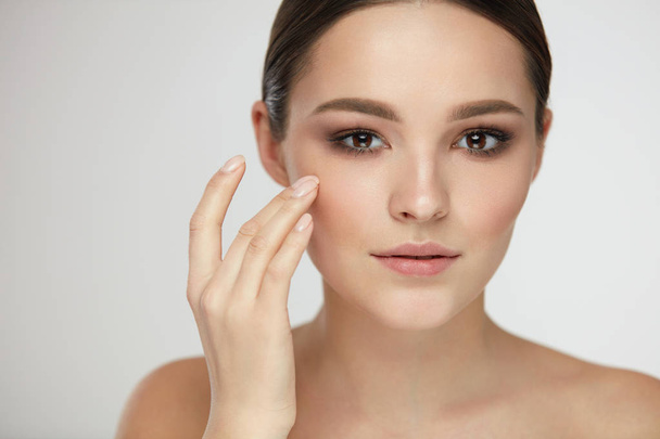 Cosmetic Face Care. Young Woman Caressing Facial Skin - Fotó, kép