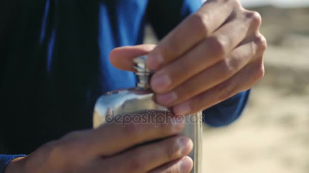 Tired man drinks last drops of water from flask - Imágenes, Vídeo