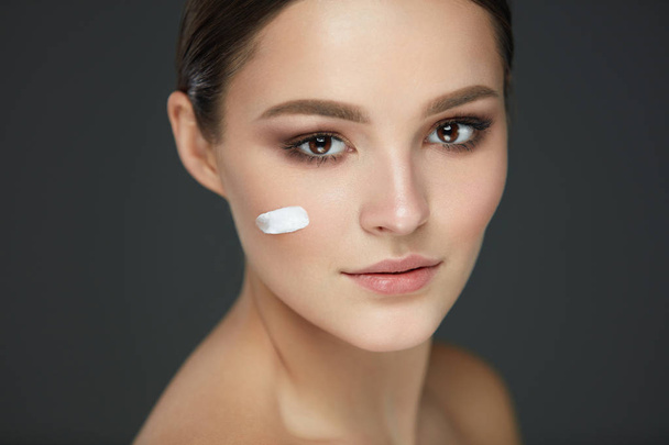 Beauty Woman Face. Girl With Stripe Of Face Cream On Fresh Skin - Photo, Image