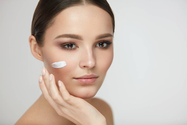 Beautiful Woman Face With Cream On Fresh Soft Skin. Cosmetics - Foto, afbeelding