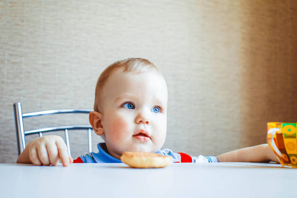 The child is sitting at the table - Photo, Image