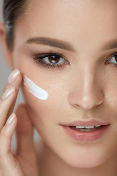 Beauty Cosmetics. Sexy Girl Face With Cosmetic Cream On Skin - Valokuva, kuva