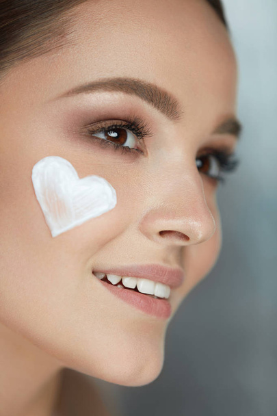 Beauty Skin Care. Woman With Heart Of Cream On Face - Fotó, kép