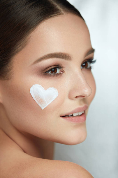Beautiful Happy Woman With Heart Of Cream On Beauty Face Skin - Photo, Image