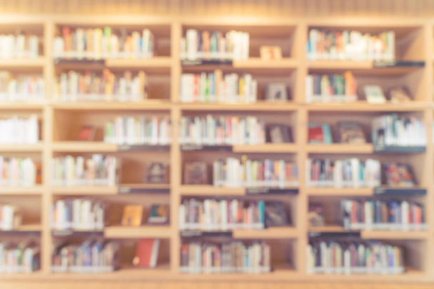 blurred bookshelf in library room - Fotó, kép