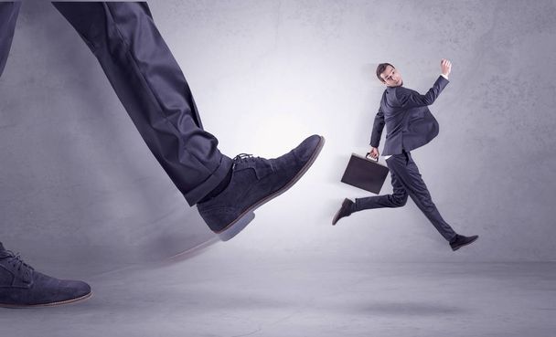 Foot kicking, businessman flying - Φωτογραφία, εικόνα