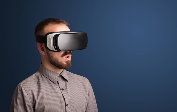 Businessman with virtual reality goggles - 写真・画像