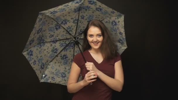 Young woman rotating umbrella - Filmati, video