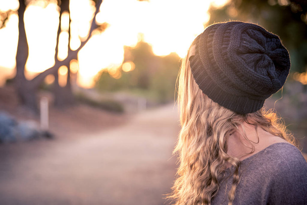 A female model with a beanie during golden hour. - Photo, Image