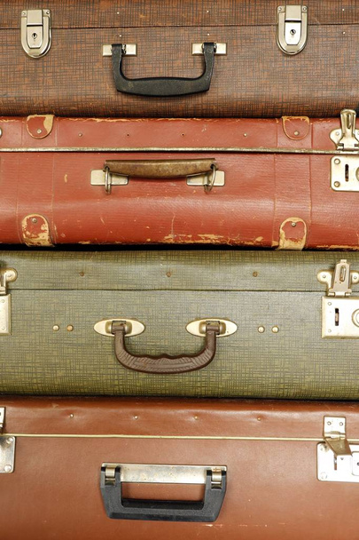 Colorful retro suitcase on a beige background - Fotó, kép
