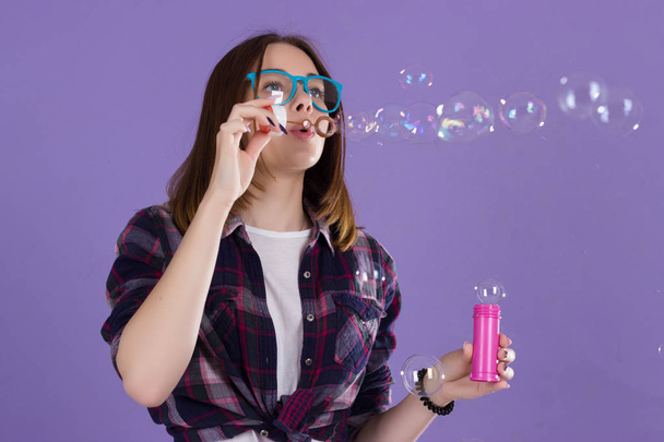 Young cute girl blows bubbles, pretty woman - Zdjęcie, obraz