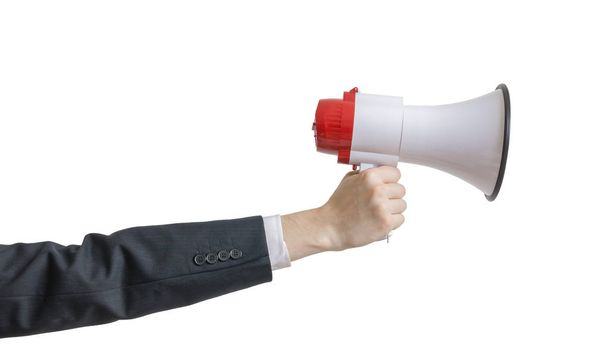 Hand is holding megaphone. Isolated on white background. - Фото, изображение