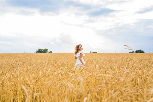 happiness, nature, summer, autumn, vacation and people concept - young woman in the field. - Photo, image