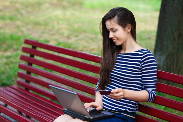 woman with laptop and bank card outdoors - Photo, Image