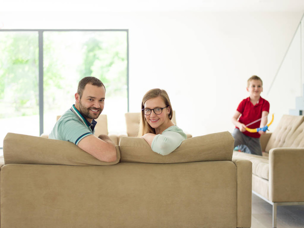 family with little boy enjoys in the modern living room - 写真・画像