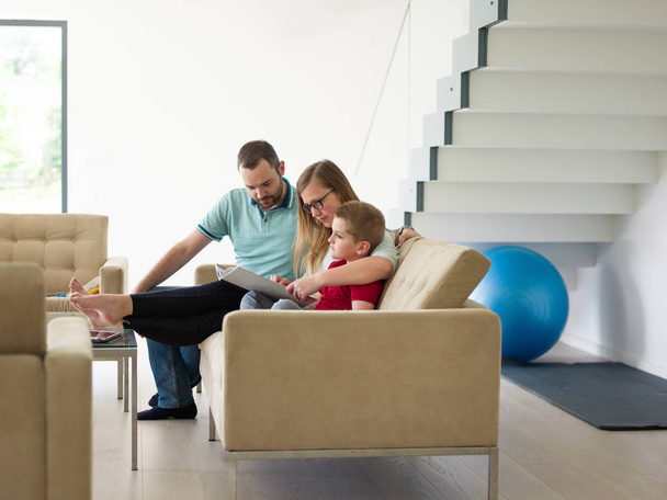 family with little boy enjoys in the modern living room - Foto, afbeelding