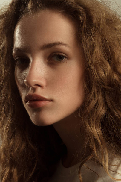 Beautiful girl portrait in studio with curly hair - Foto, Imagen