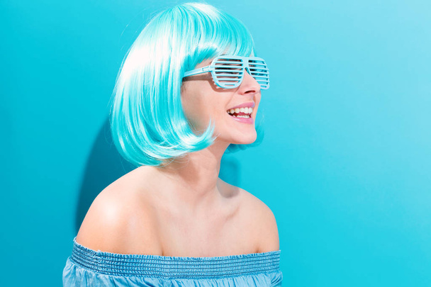 Beautiful woman in a bright blue wig - Fotografie, Obrázek