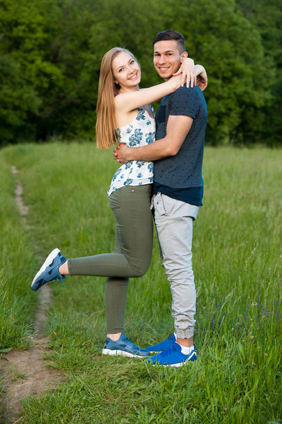 Active young couple having fun in park on hot summer agetrnoon - Фото, зображення