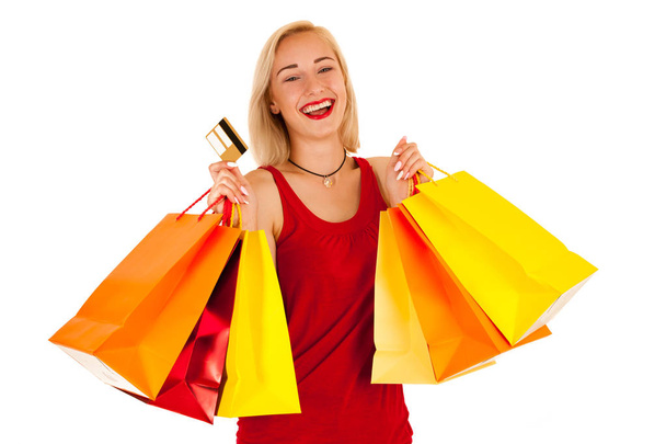 Attractive blonde young woman with shopping bags isolated - Fotó, kép