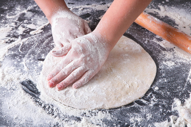 Baking concept. Hands roll dough on black background. - Fotó, kép