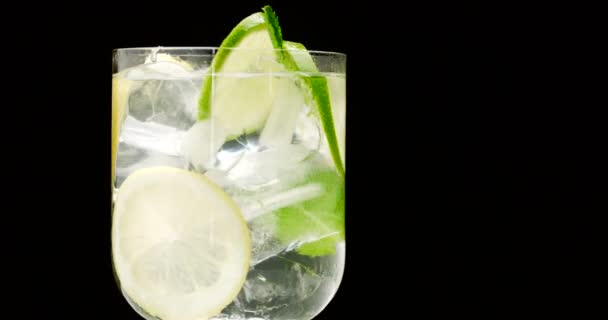closeup of coctail. Mojito, tonik water with mint and lemon and lime and ice cubes - Footage, Video
