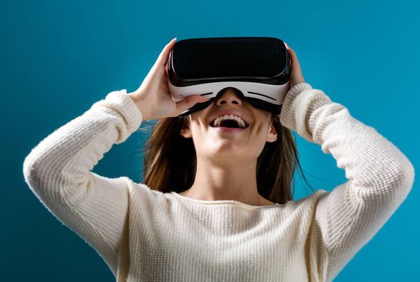 Young woman using virtual reality headset - 写真・画像