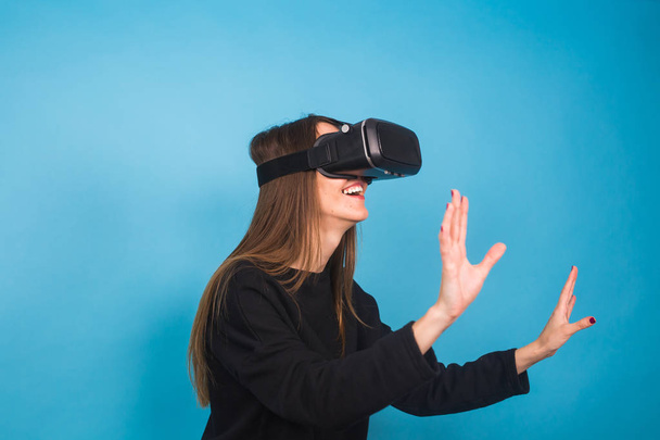 Happy young woman using a virtual reality headset. - Photo, Image