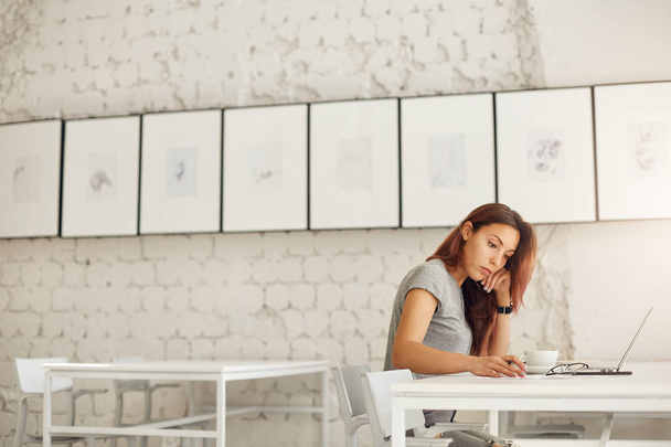 Wide shot of female worker or student doing her daily job designing prints online or studying in a bright studio environment. Education concept. - Foto, Imagen