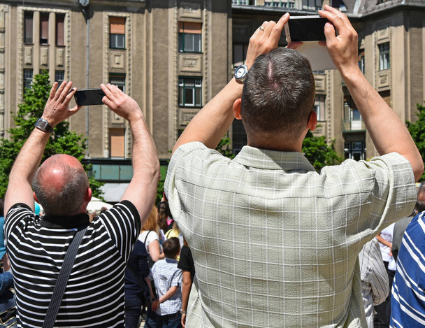 Чоловіки фотографують мобільні телефони
 - Фото, зображення
