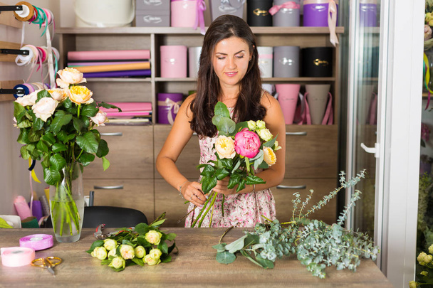 Pretty woman in the flower shop - Photo, Image