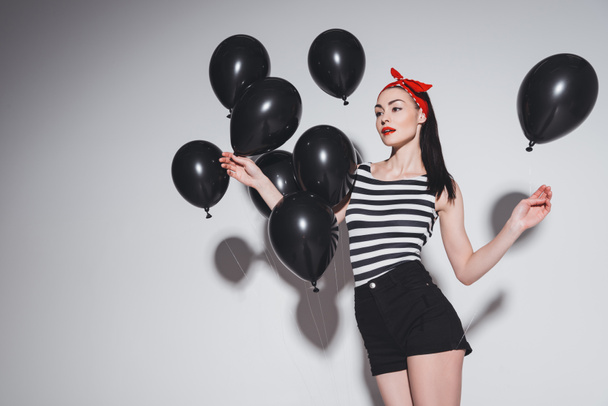 Stylish woman with black balloons - Zdjęcie, obraz
