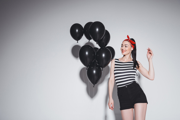 Stylish woman with black balloons - Zdjęcie, obraz