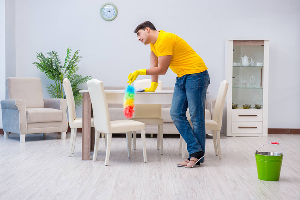 Young man doing chores at home - Foto, Imagen