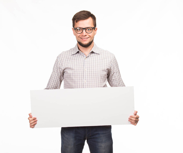 Young happy man showing presentation, pointing on placard - Foto, Imagem