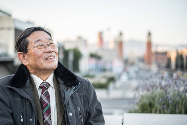 Japanse senior oude man buitenshuis lachende en gelukkig portret - Foto, afbeelding