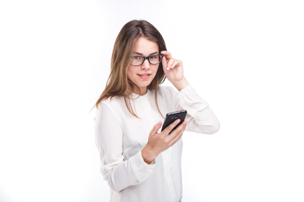 Portrait happy, smiling woman texting on her smart phone, isolated white background. Communication concept. Internet, phone addiction - Foto, imagen